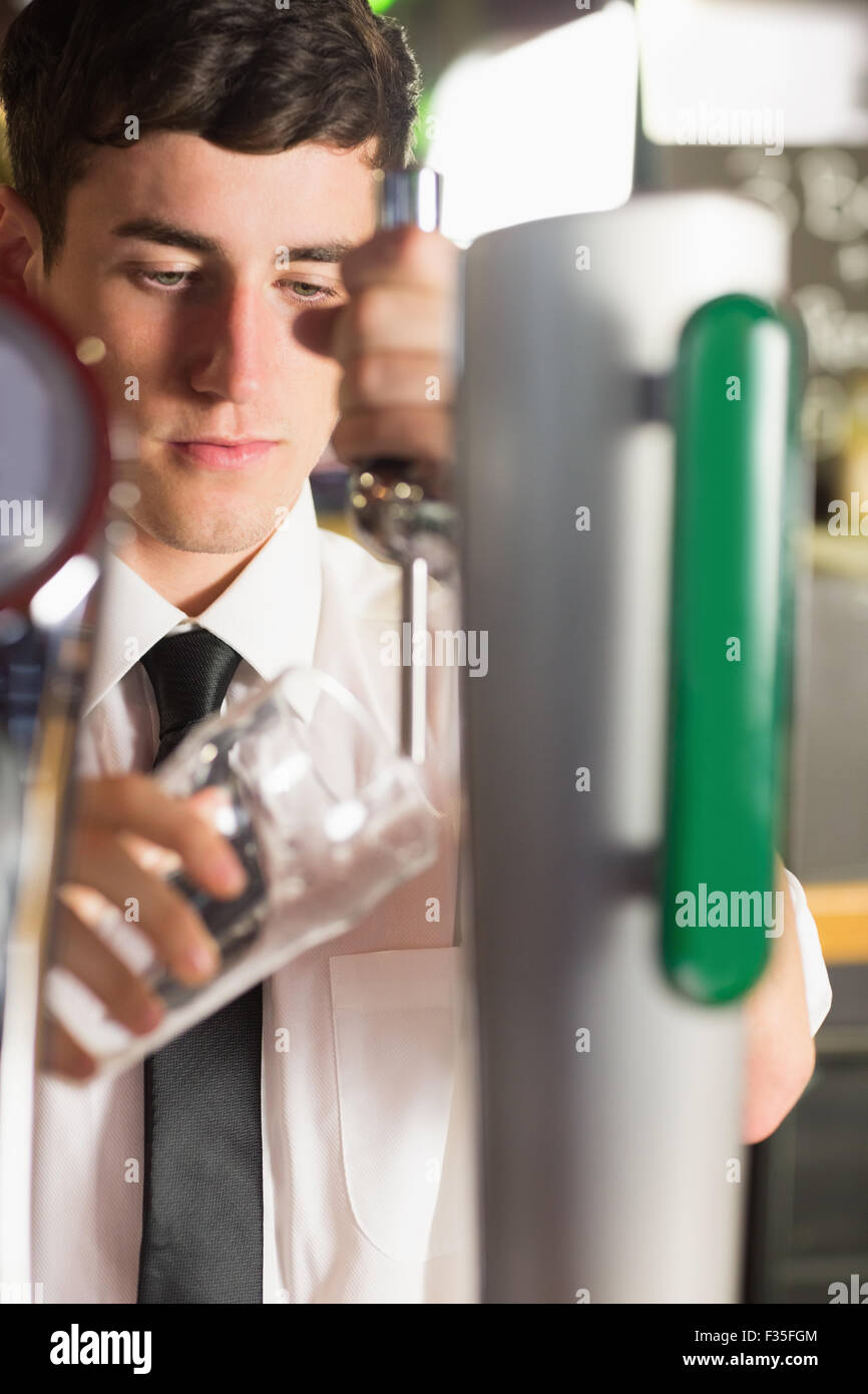 Nahaufnahme der Barkeeper mit Glas bei Bierzapfanlage Stockfoto