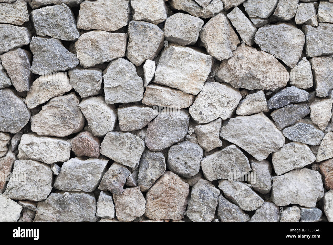 Nahtlose Hintergrund Fototexturen Steinmauer grau grobem Granit Stockfoto