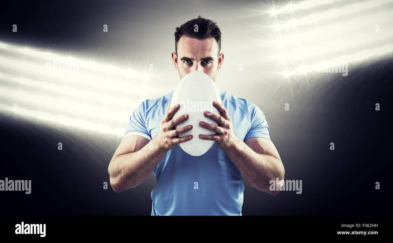 Zusammengesetztes Bild des Rugby-Spieler Blick in die Kamera mit ball Stockfoto