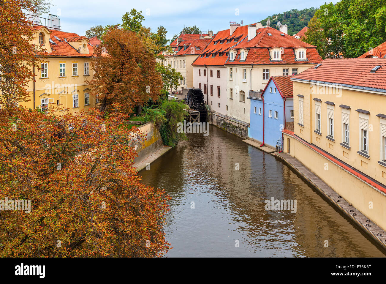 Schmalen Kanal zwischen bunten Häusern mit roten Dächern und herbstliche Bäume in Prag, Tschechien. Stockfoto