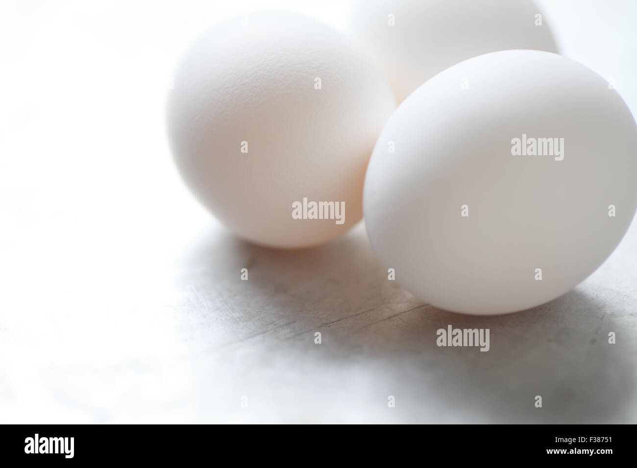 Weißen Eiern auf einer zerkratzten Metallfläche mit Platz für Kopie Stockfoto