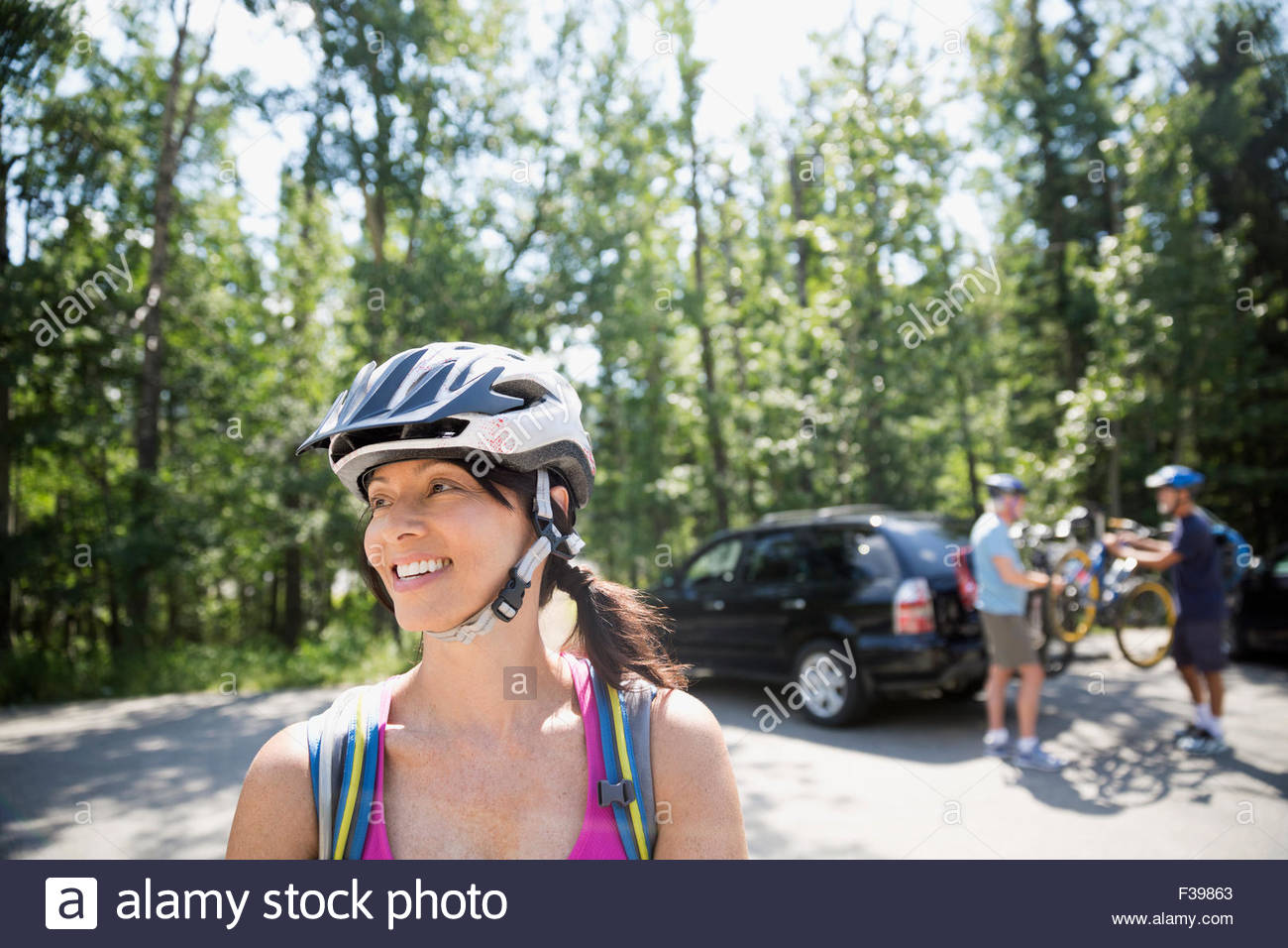 Lächelnde Frau mit Mountain Bike Helm Stockfoto