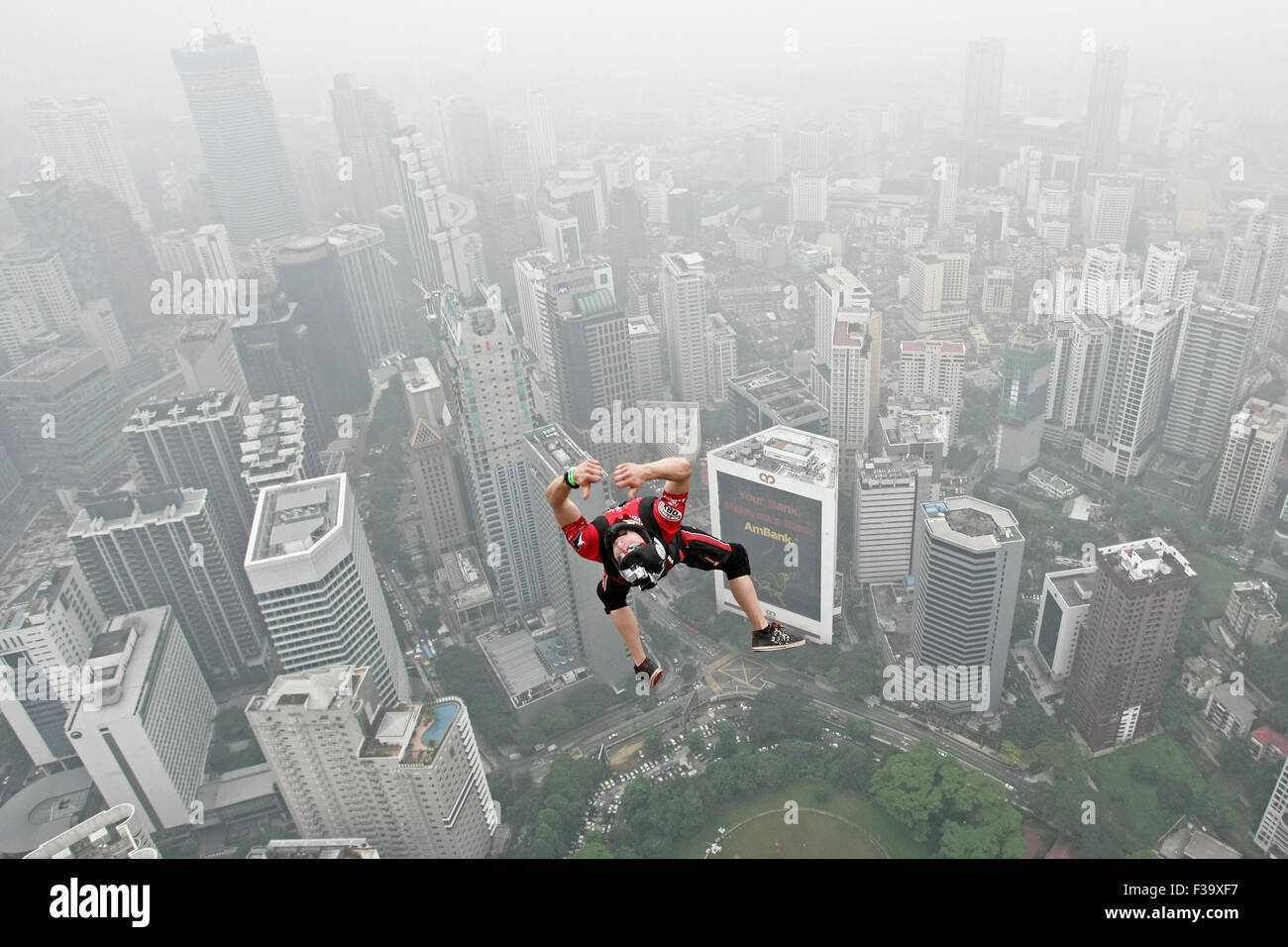 KL, Kuala Lumpur, Malaysia. 2. Oktober 2015. Base-Jumper springt aus dem 300 m (984 ft) hoch. Sie sind Piictured gegen die Skyline, die eingehüllt durch ein dicker Nebel während der Kuala Lumpur Tower International Jump in Kuala Lumpur, Malaysia, 2. Oktober 2015. Mehr als 100 Base-Jumper nehmen an dieser Extremsport-Veranstaltung, die seinem 15. Jahr betritt. Der Dunst schwebt über Malaysia verursacht durch die laufenden Plantage und Waldbränden in den nahe gelegenen indonesischen Provinzen von Sumatra und Kalimantan. Bildnachweis: Mohd Hafiz/ZUMA Draht/Alamy Live-Nachrichten Stockfoto