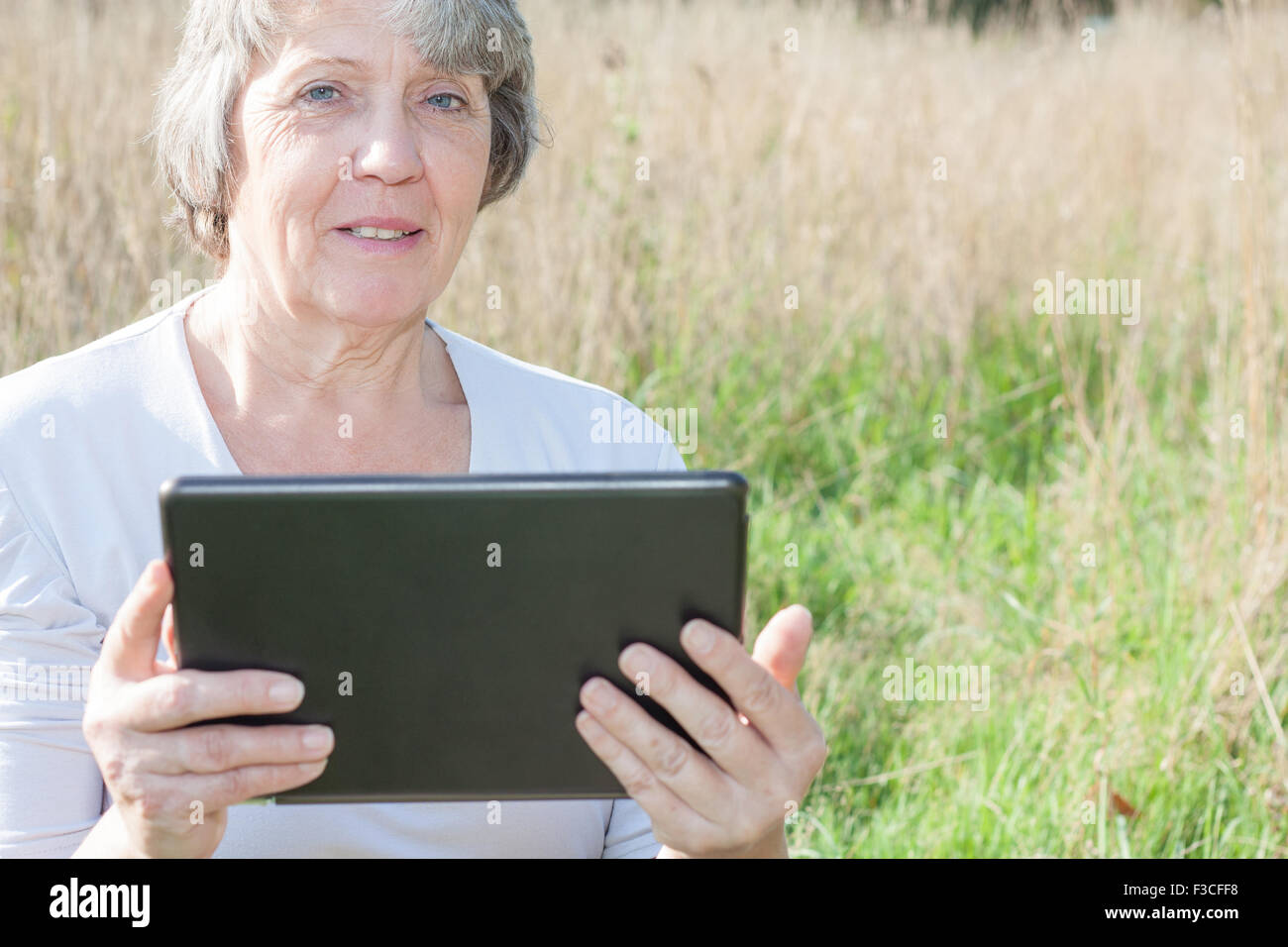 Ältere Frau mit Tablet-Gerät Stockfoto