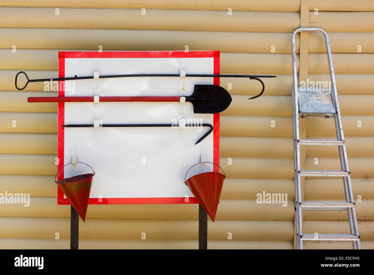 Feuer-Board mit roten Eimer, ein Haken, eine Schaufel und eine Leiter-Konzept. Stockfoto