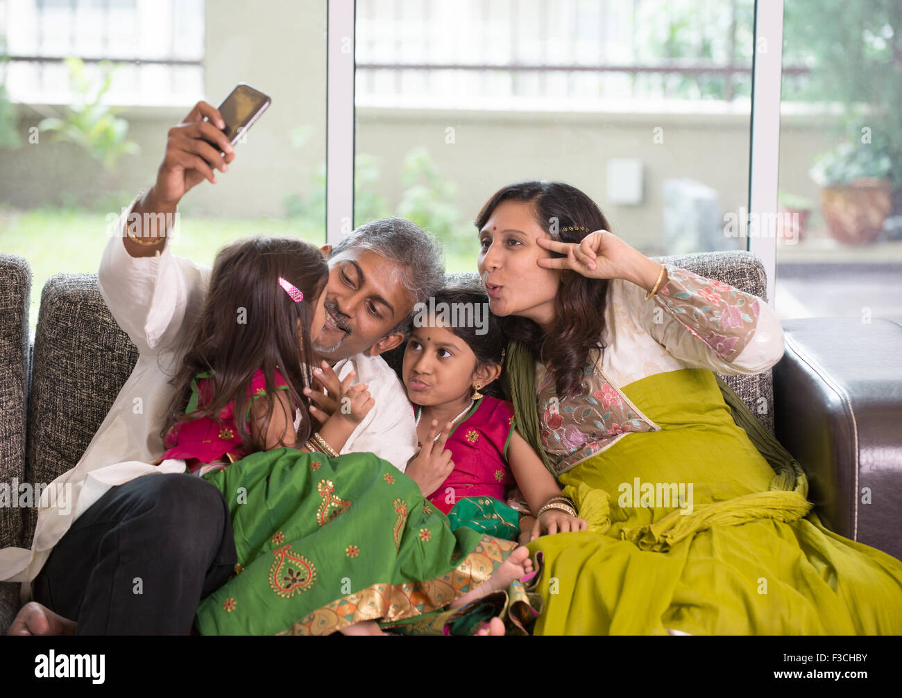 Asiatische indische Familie Selfie oder selbst fotografieren zu Hause. Eltern und Kinder indoor Lifestyle. Stockfoto
