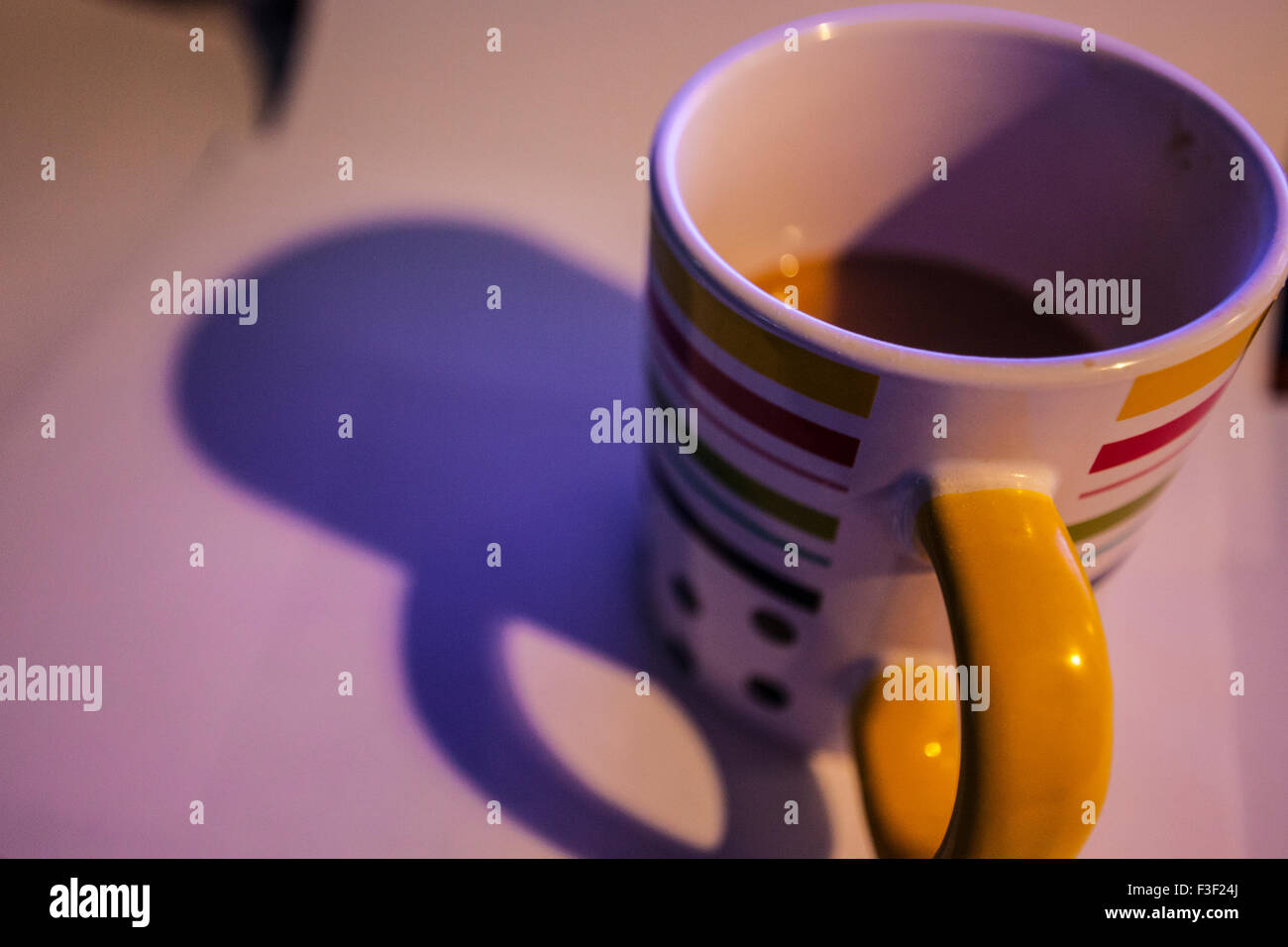 Eine halb leere Kaffeetasse auf weißem Papier Stockfoto