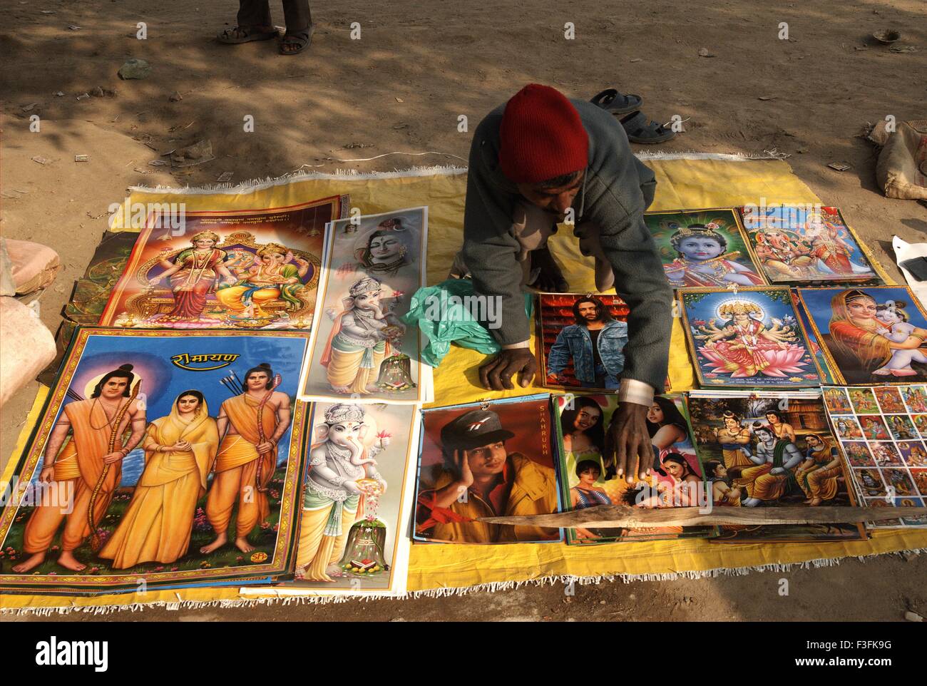Eine Hawker verkauft Fotos Poster von Bollywood-Film Schauspieler Indische Gottheiten Ardh Kumbh Mela;; Indien Stockfoto