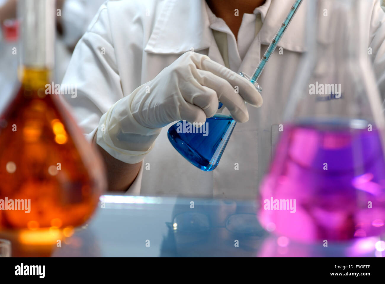 Die pharmazeutische Forschung Laboratry lab chemischen flüssigen Farben Kolben und Reagenzgläser lady hand Forschungsprojekt - Rmm 123399 Stockfoto