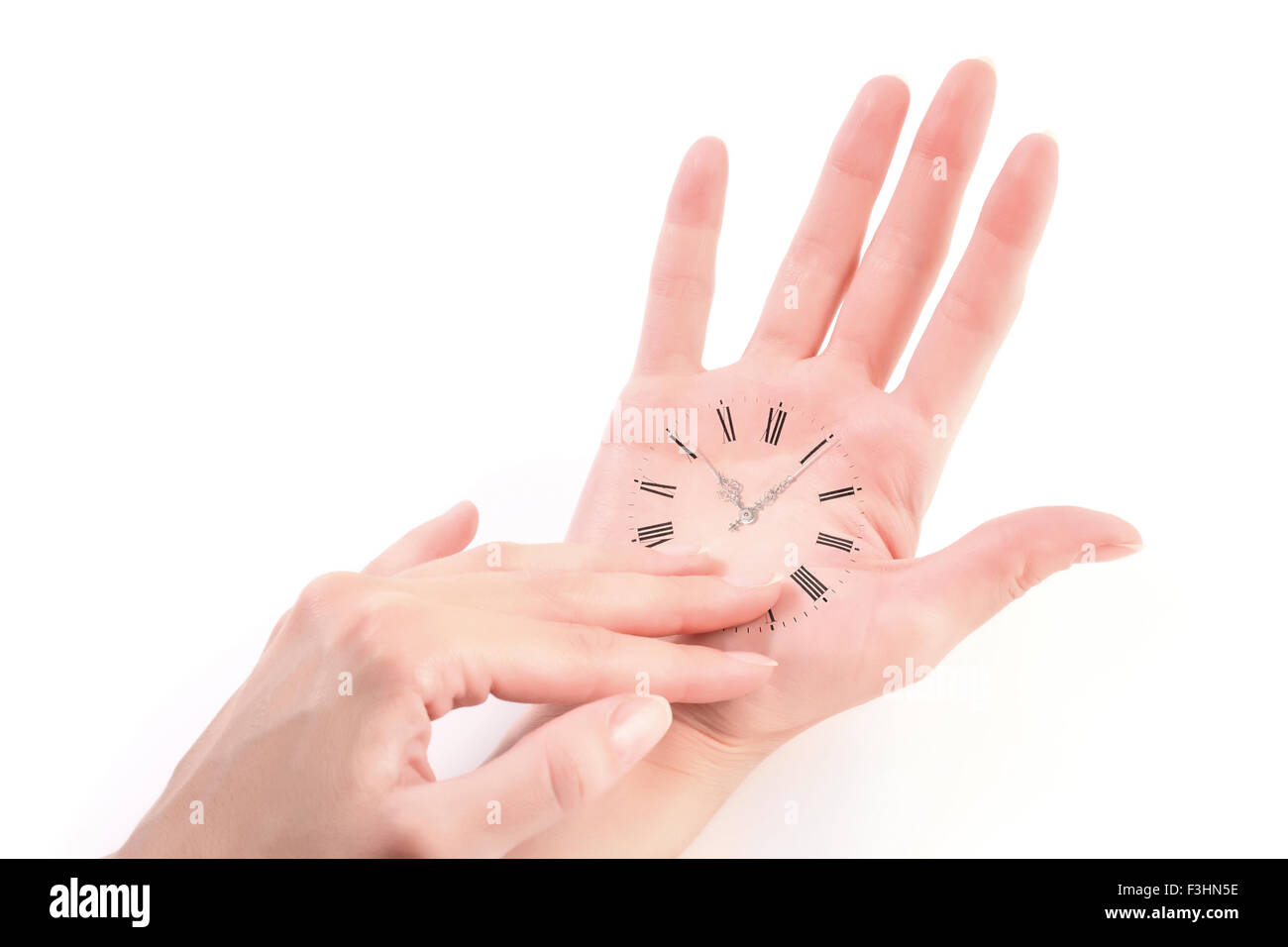 schöne weibliche Hand als surrealistische Vintage Uhr isoliert auf weiss Stockfoto