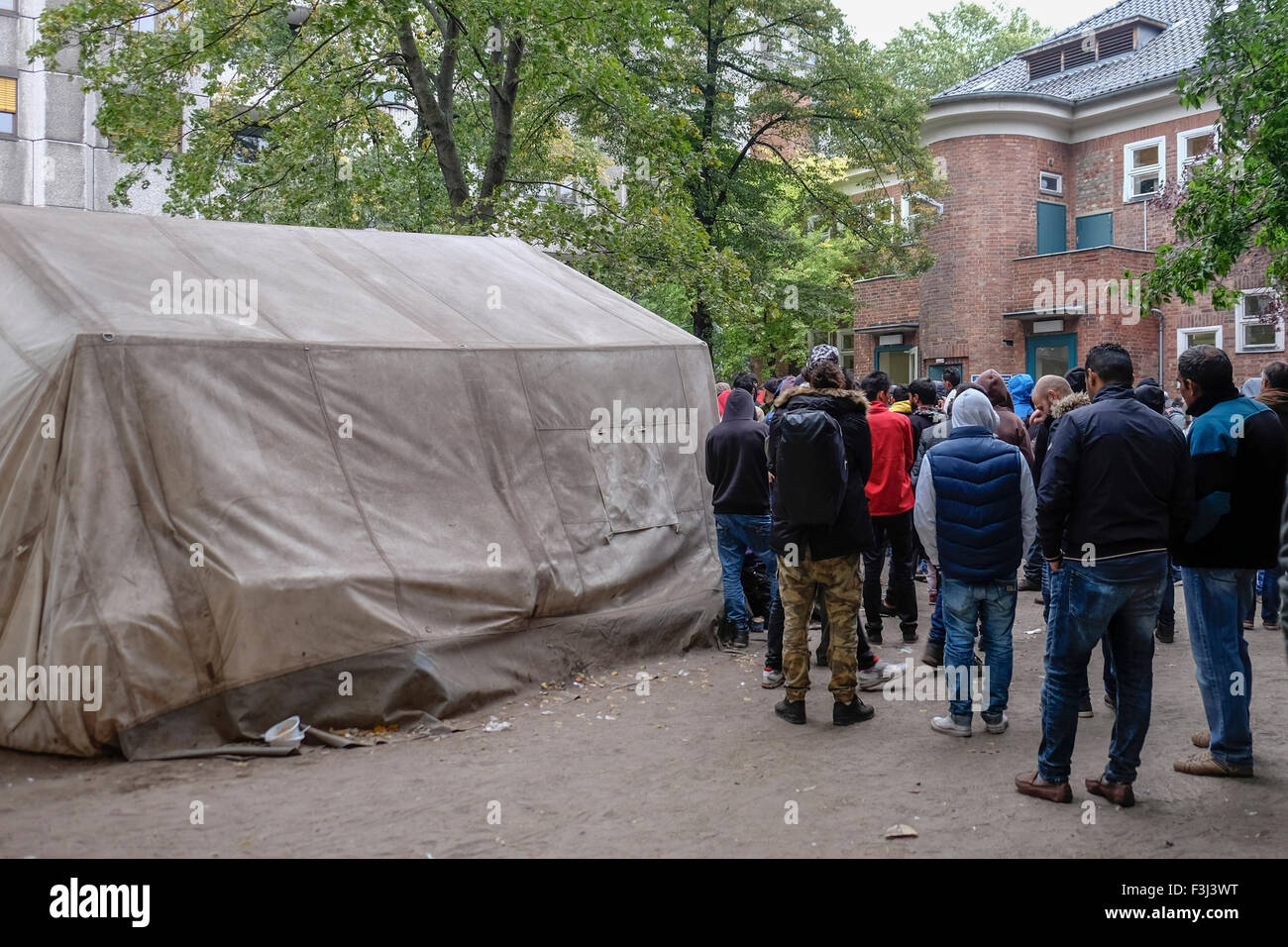 Berlin, Deutschland, 7. Oktober 2014. Berlin begrüßt Flüchtlinge jedoch die Stadt kämpft, um die Massen zu verarbeiten, die im Zentrum LaGeSo (Forschungsdefizite Für Gesundheit Und Landeserziehungsgeld) jeden Tag eintreffen. Müde Reisende kämpfen für Interview Zahlen und warten Sie, bis ihre Zahl angezeigt werden. Die wenigen glücklichen durch das Zentrum schnell aber viele ertragen Verzögerungen von Tagen oder Wochen. Kleine Zelte sprießen, decken verteilen und Kinder packen ihre kargen Besitztümer. Beamten und Freiwilligen sind lange Arbeitszeiten zu lindern die Situation und die traurige Ankünfte zu unterstützen. Bildnachweis: Eden Breitz/Alamy Live neu Stockfoto