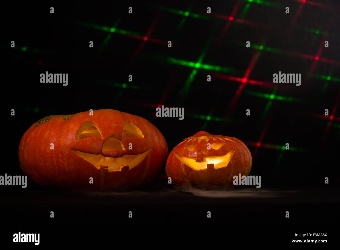 Zwei Halloween-Kürbisse speien Rauch/schwarzer Hintergrund mit Laser-Effekte Stockfoto