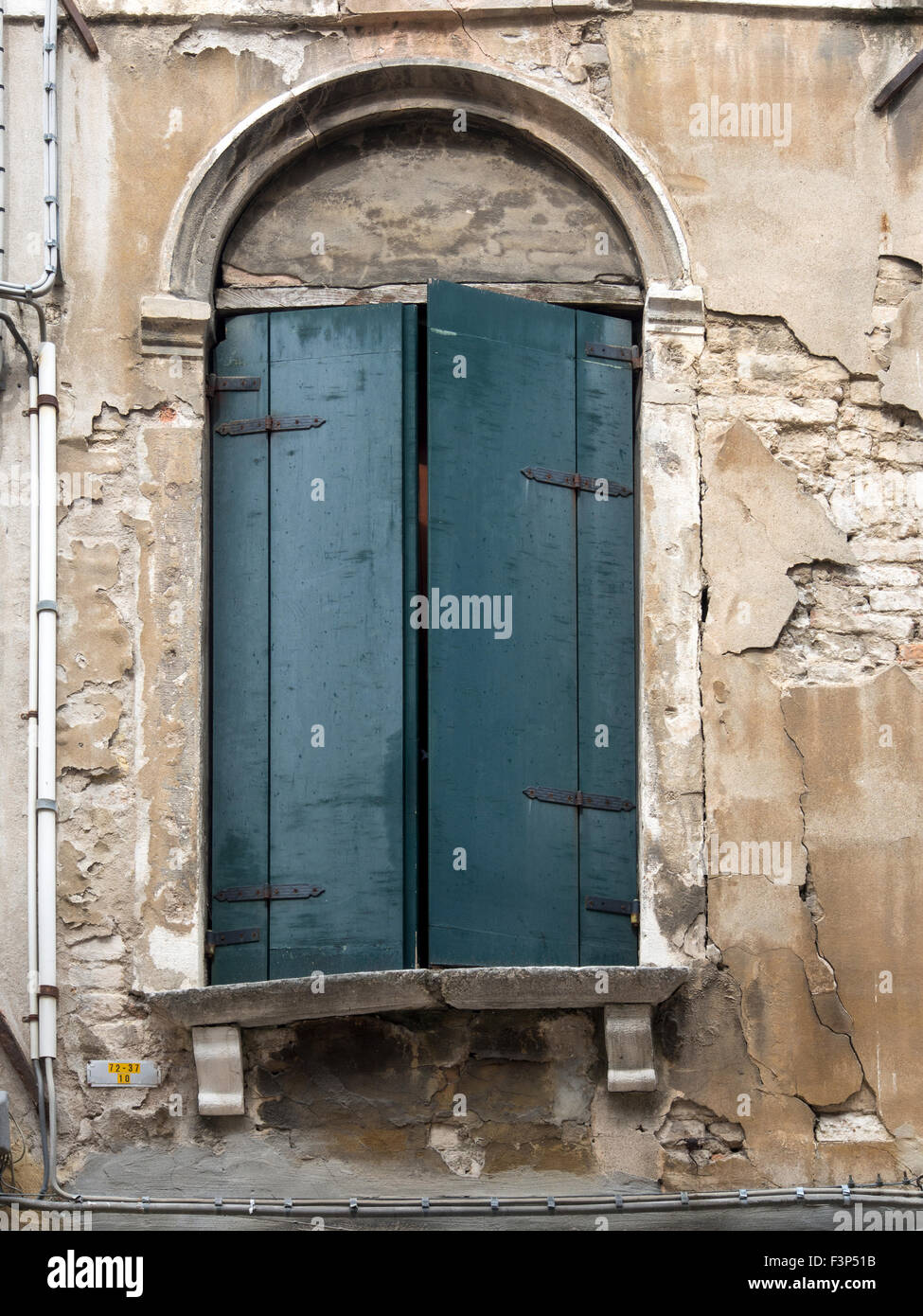 VENEDIG, ITALIEN - 05. MAI 2015: Alte hölzerne Fensterläden an einem Fenster in einem Steingebäude Stockfoto