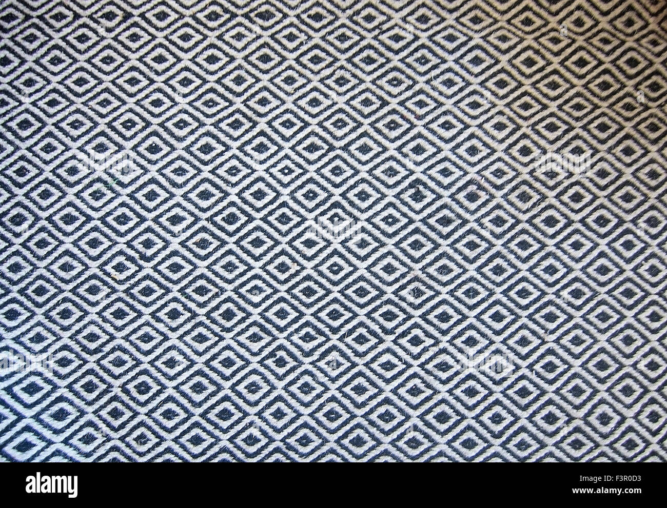 Schwarz / weiß Bodenbelag Wollteppich im klassischen Muster Hintergrund. Stockfoto