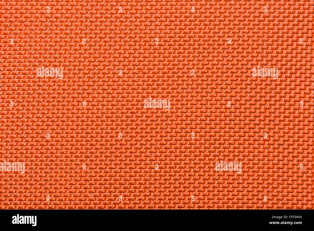Eine Makroaufnahme einer sehr dicht gewebte orange Stoff. Stockfoto