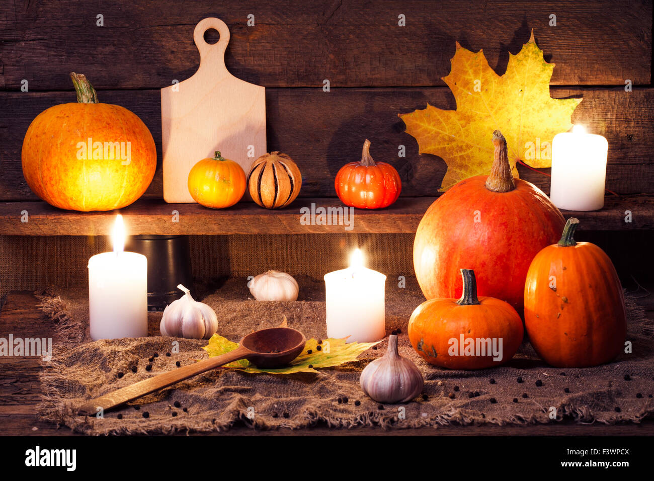 Kürbisse auf einem Holztisch mit Zubehör für die Küche Stockfoto
