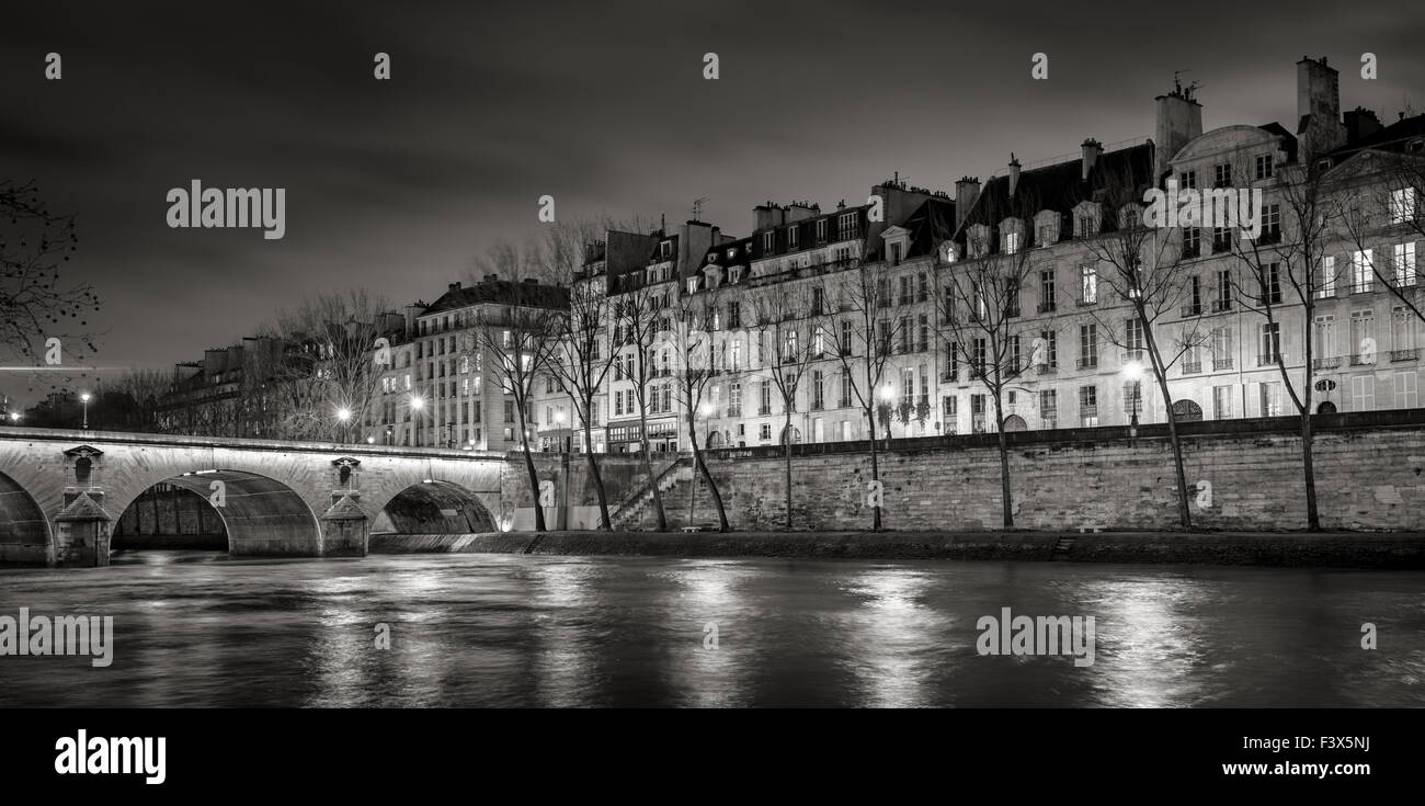 Seine River, Quai de Bourbon auf der Ile Saint Louis mit Pont Marie und abends Leuchten. Reihe von Gebäuden des 19. Jahrhunderts, Paris, Frankreich Stockfoto