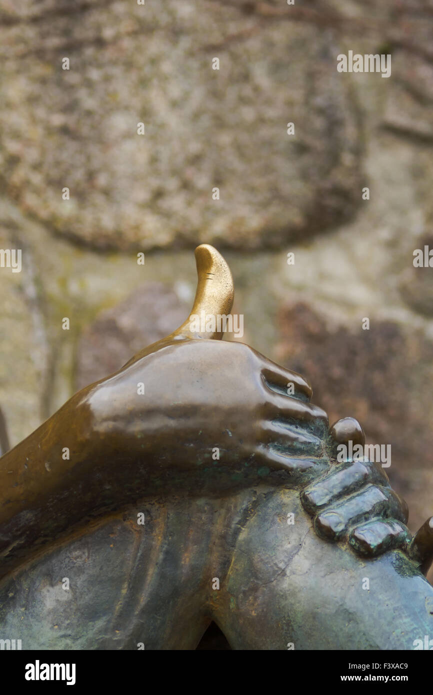 Den goldenen Daumen Stockfoto