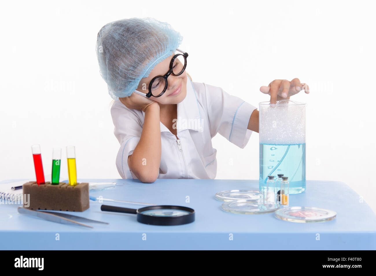 Chemiker Mädchen steckte einen Finger in Seifenwasser Stockfoto