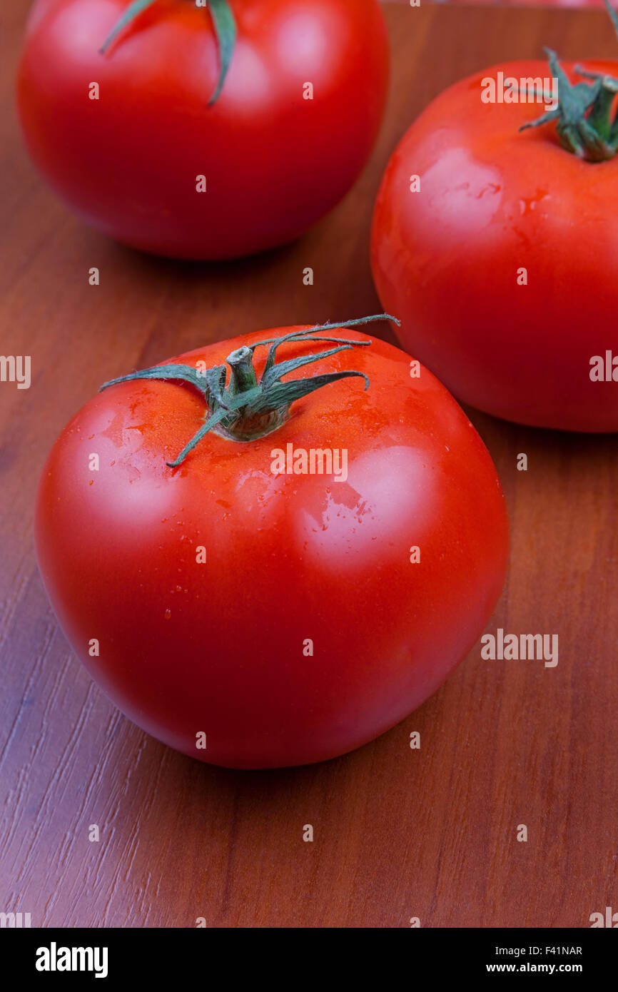 rote Tomaten auf einer Holzoberfläche Stockfoto