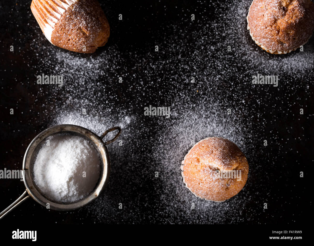 Einige Zucker Puderzucker Madeleines und Sieb Stockfoto