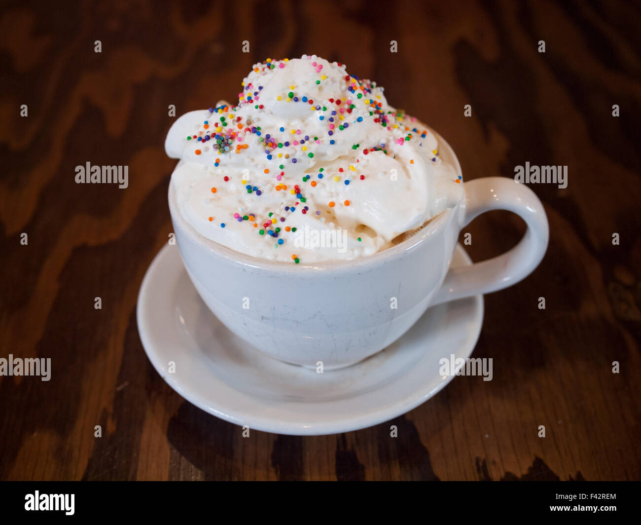 Eine heiße Geburtstag Kuchen Milchkaffee mit bunten Streuseln und Schlagsahne aus d'Lish Tish Café in Saskatoon, Saskatchewan, Kanada. Stockfoto