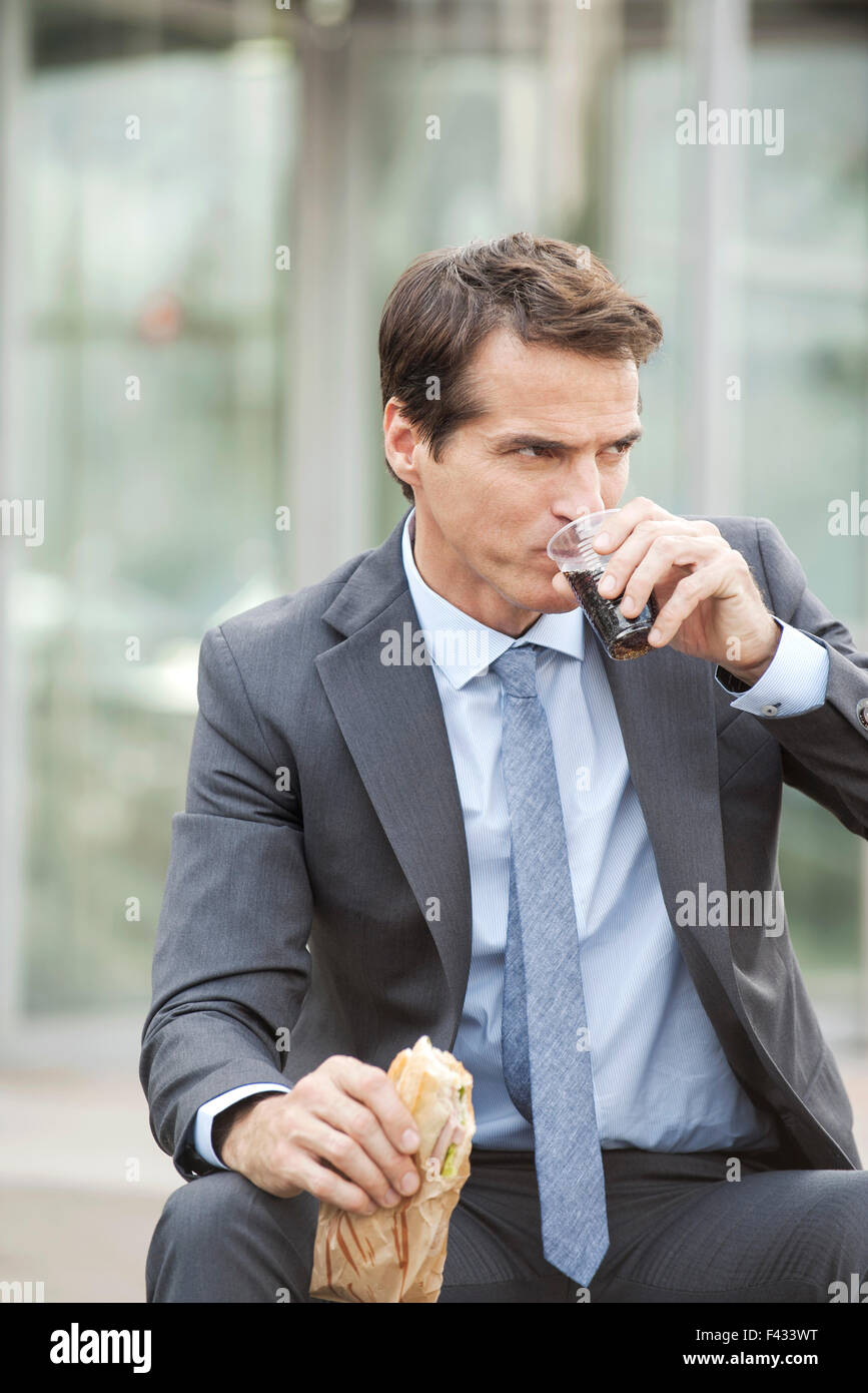 Führungskraft mit Mittagessen im freien Stockfoto