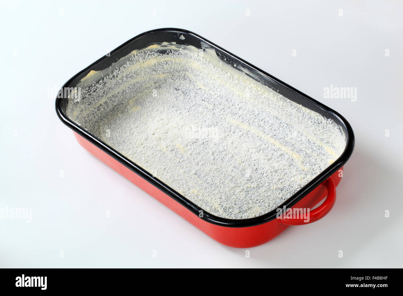 gefettete Backform mit Dehydriertes Coconut bedeckt Stockfoto