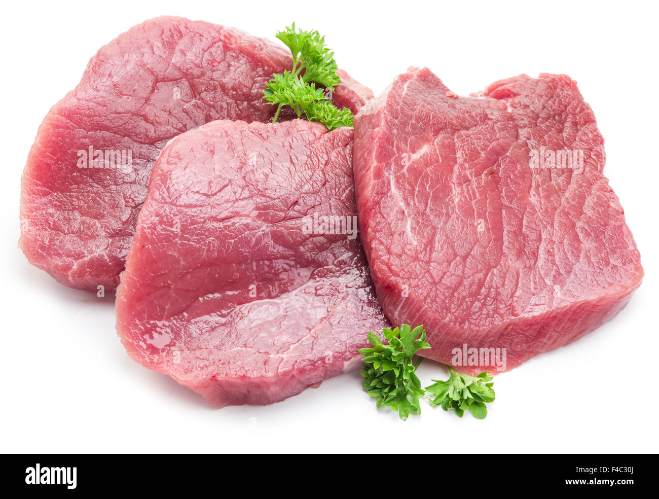 Rohes Rindfleisch Steaks mit Petersilie auf weißem Hintergrund. Stockfoto
