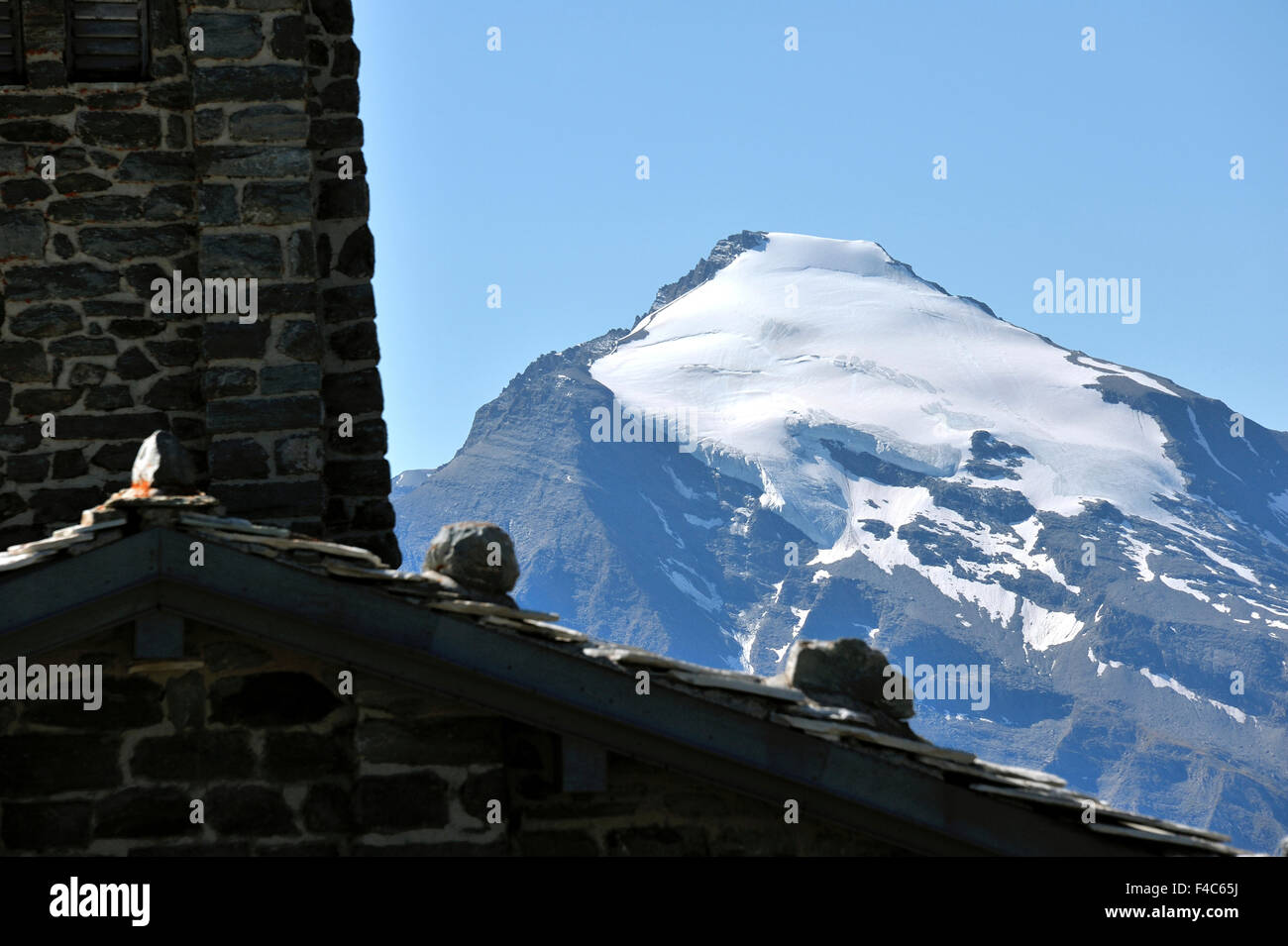 Blick zum Pic de Charbonnel neben der Kirche auf dem Pass, Iseran, Französische Alpen, Frankreich Stockfoto