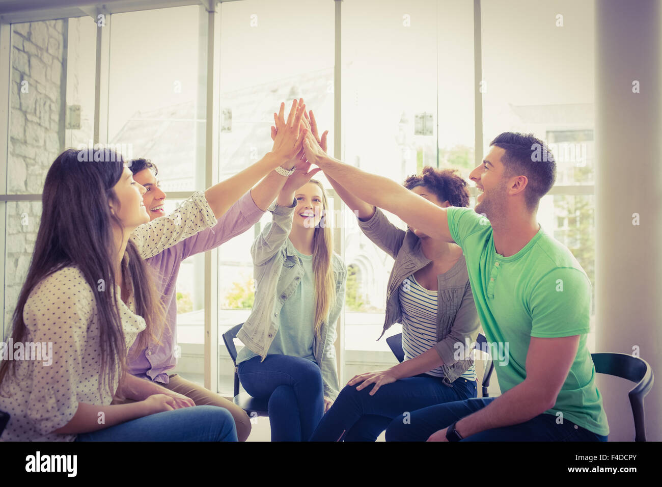 Schüler sitzen im Kreis zusammen arbeiten Stockfoto