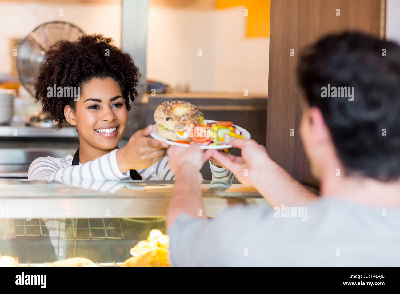 Kellnerin serviert Mittagessen an Kunden Stockfoto