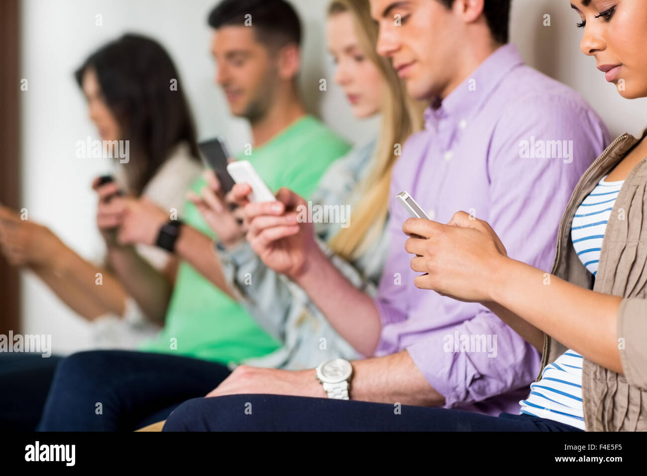 Studenten, die mit ihren Smartphones in Folge Stockfoto