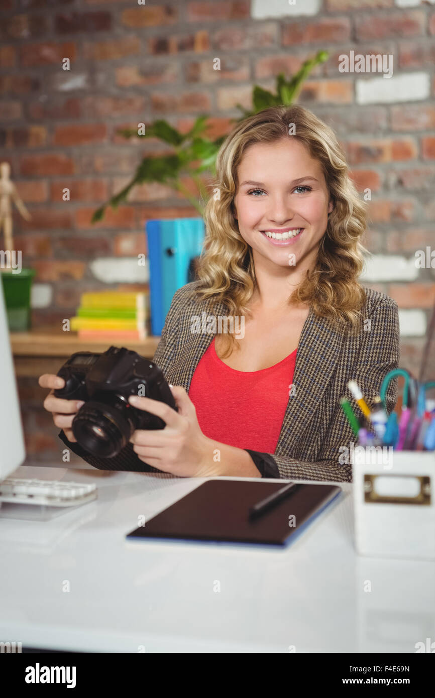Porträt von lächelnden Frau Holding Kamera Stockfoto