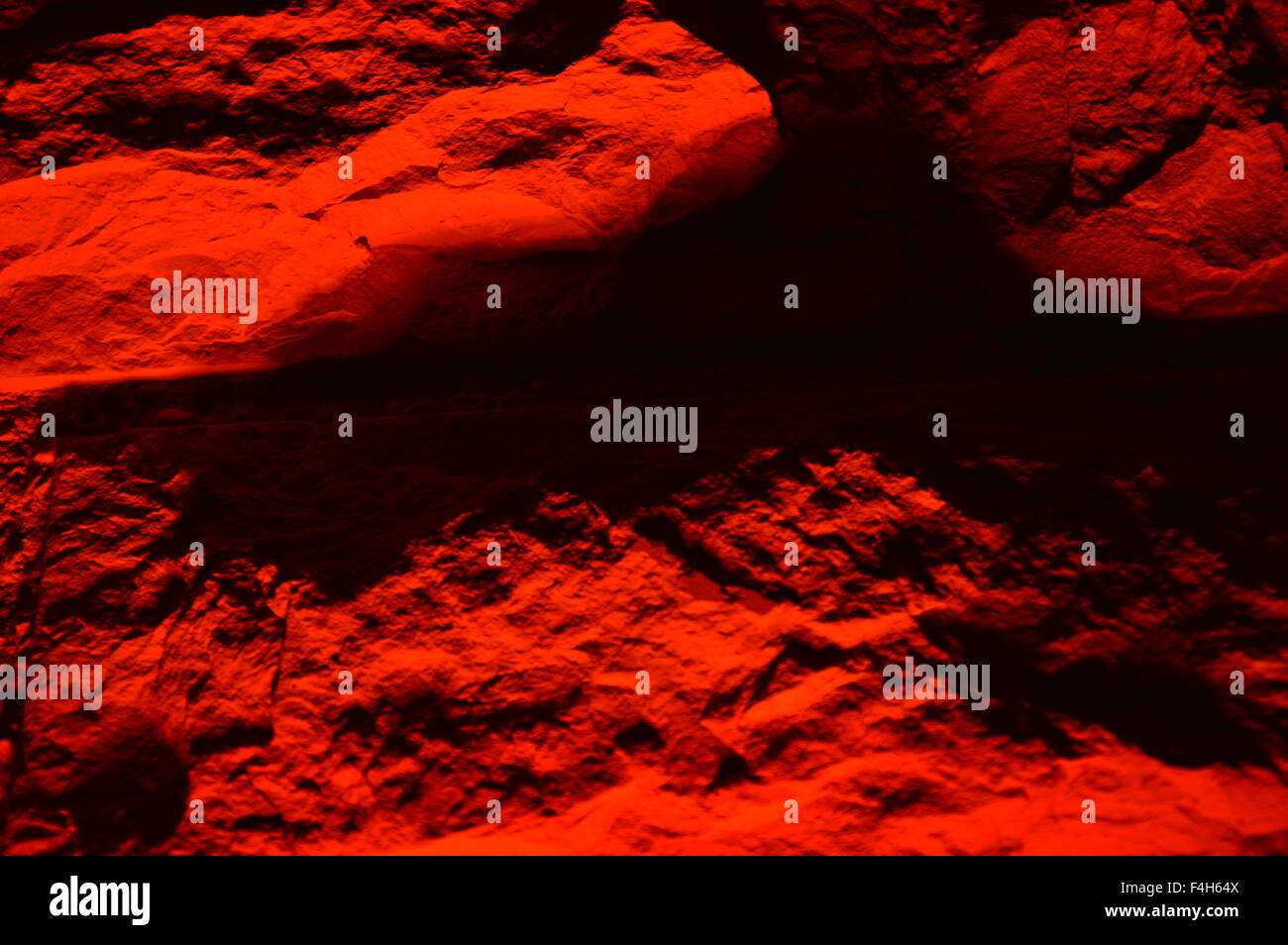 Wand in Natursteine in rotes Licht, zoom Stockfoto
