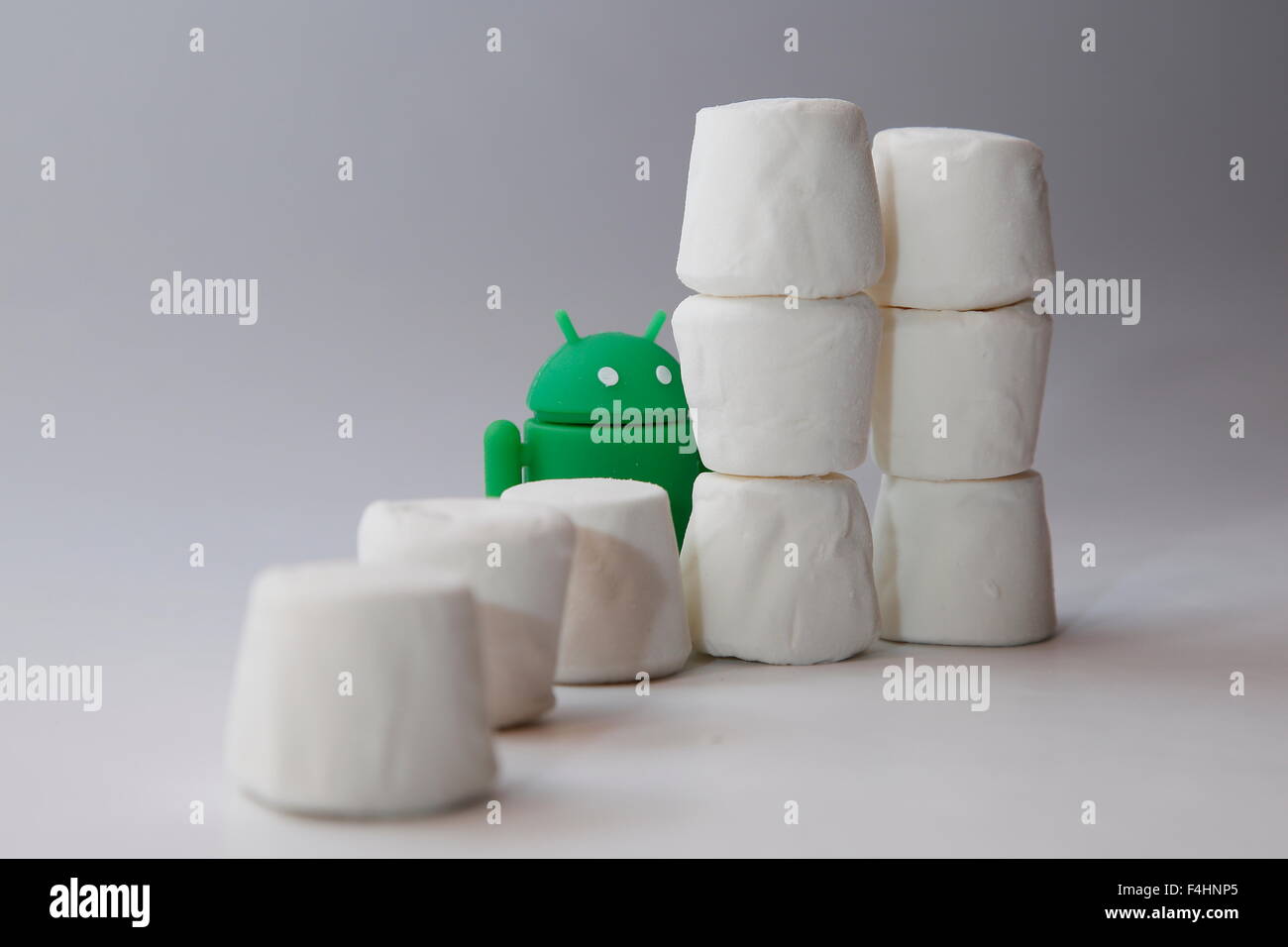 Ein grüner Android Roboter späht aus in einem Haufen von Marshmallows.  Googles Android OS ist unter dem Codenamen Marshmallow Stockfoto