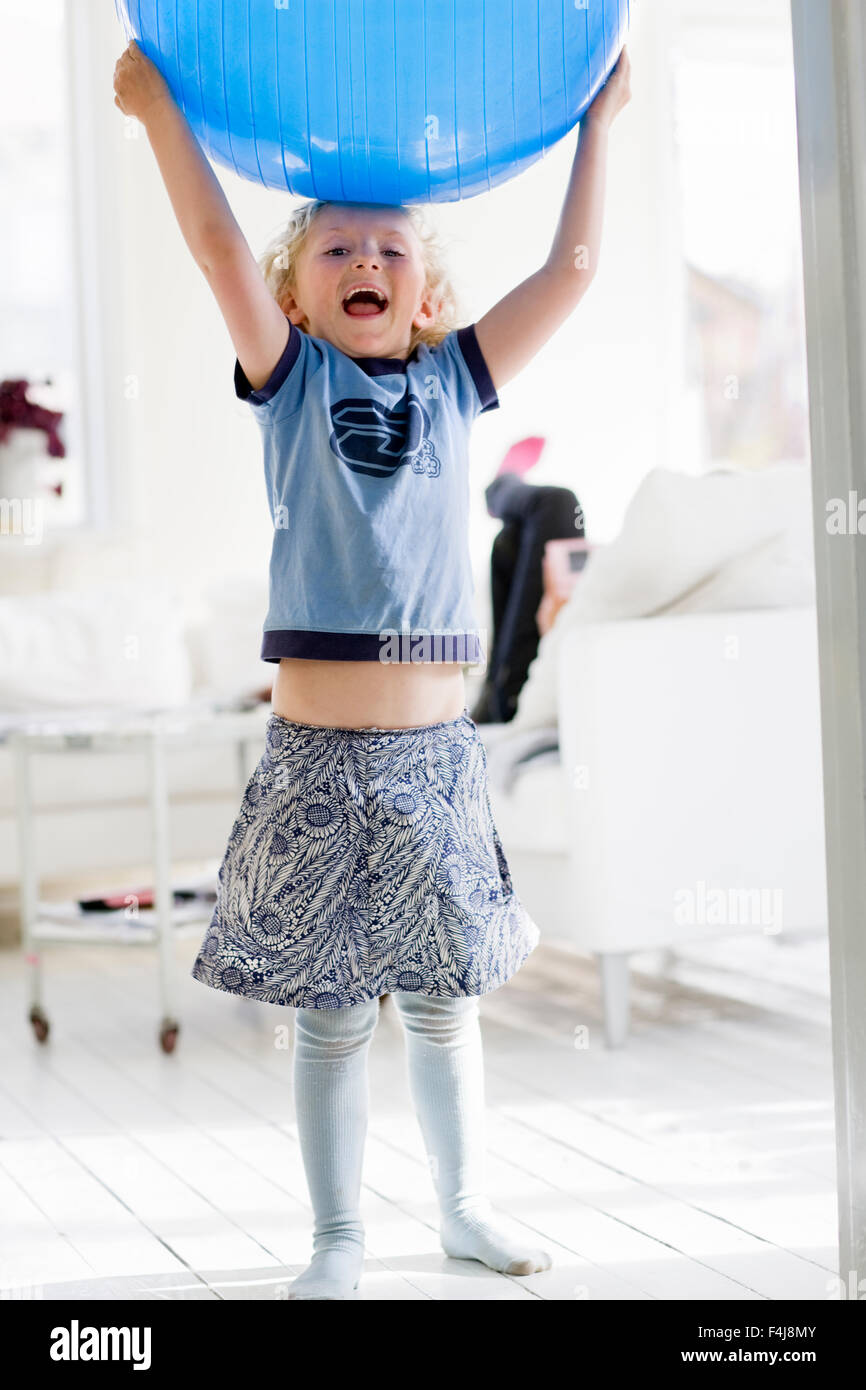 Mädchen spielen mit einem großen blauen Ball, Schweden. Stockfoto