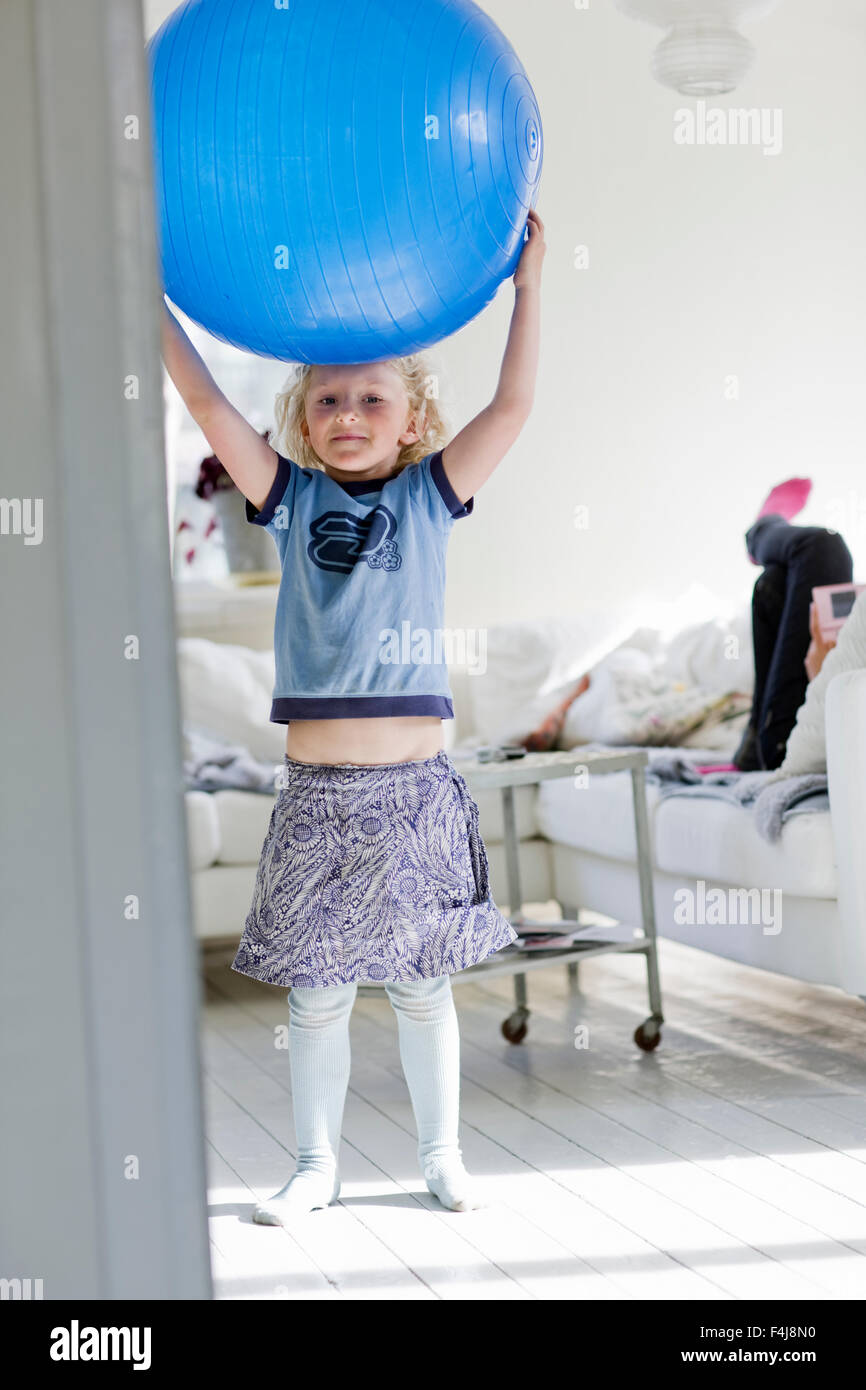Mädchen spielen mit einem großen blauen Ball, Schweden. Stockfoto