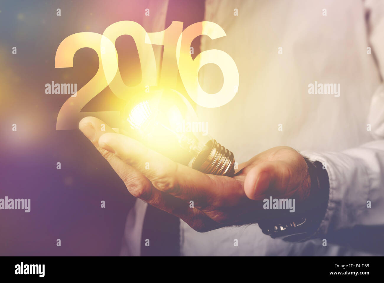 Glückliche neue 2016 Geschäftsjahr, Geschäftsmann mit Glühbirne und Reihe 2016, Retro-getönten Bild, selektiven Fokus. Stockfoto