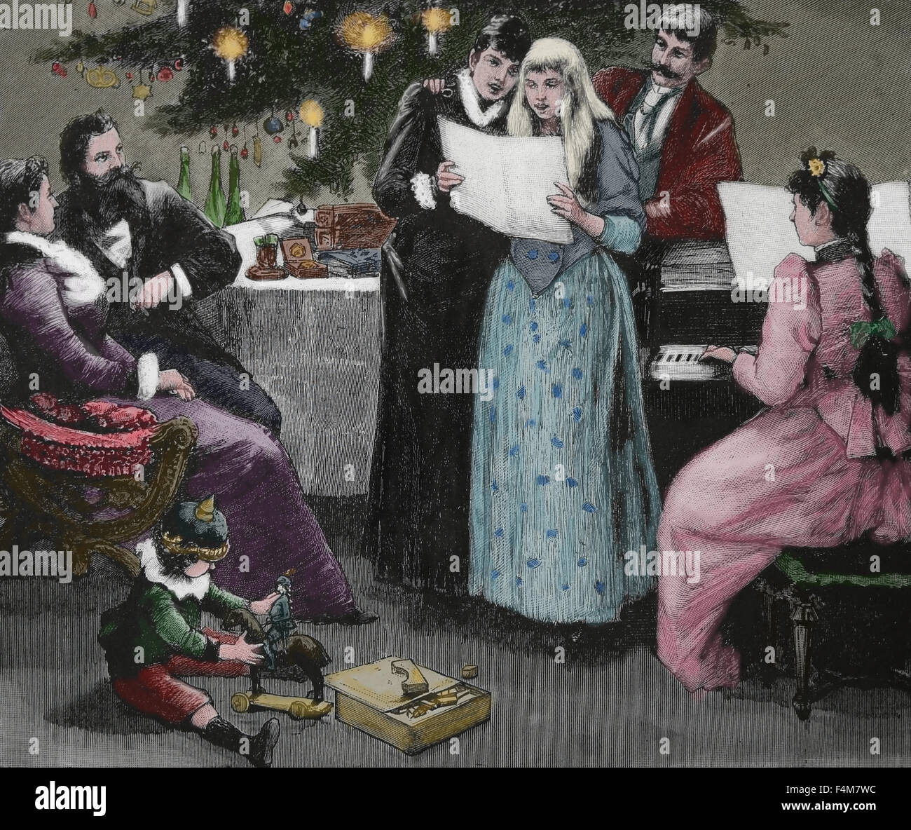 Familie Weihnachtslied singen. Gravur. des 19. Jahrhunderts. Farbe. Stockfoto