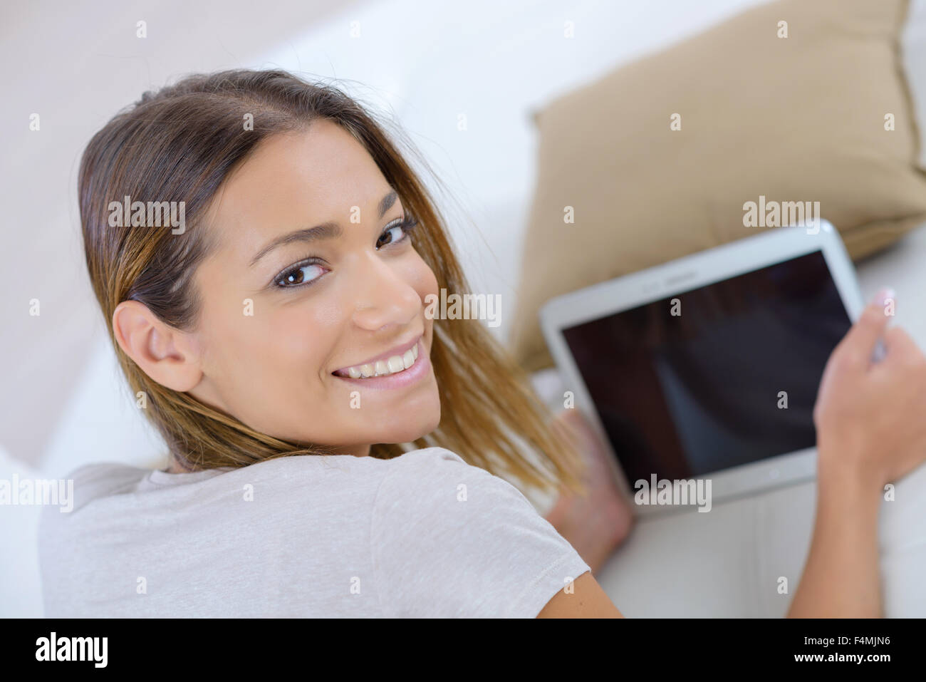 Frau auf dem Sofa mit ihrem tablet Stockfoto