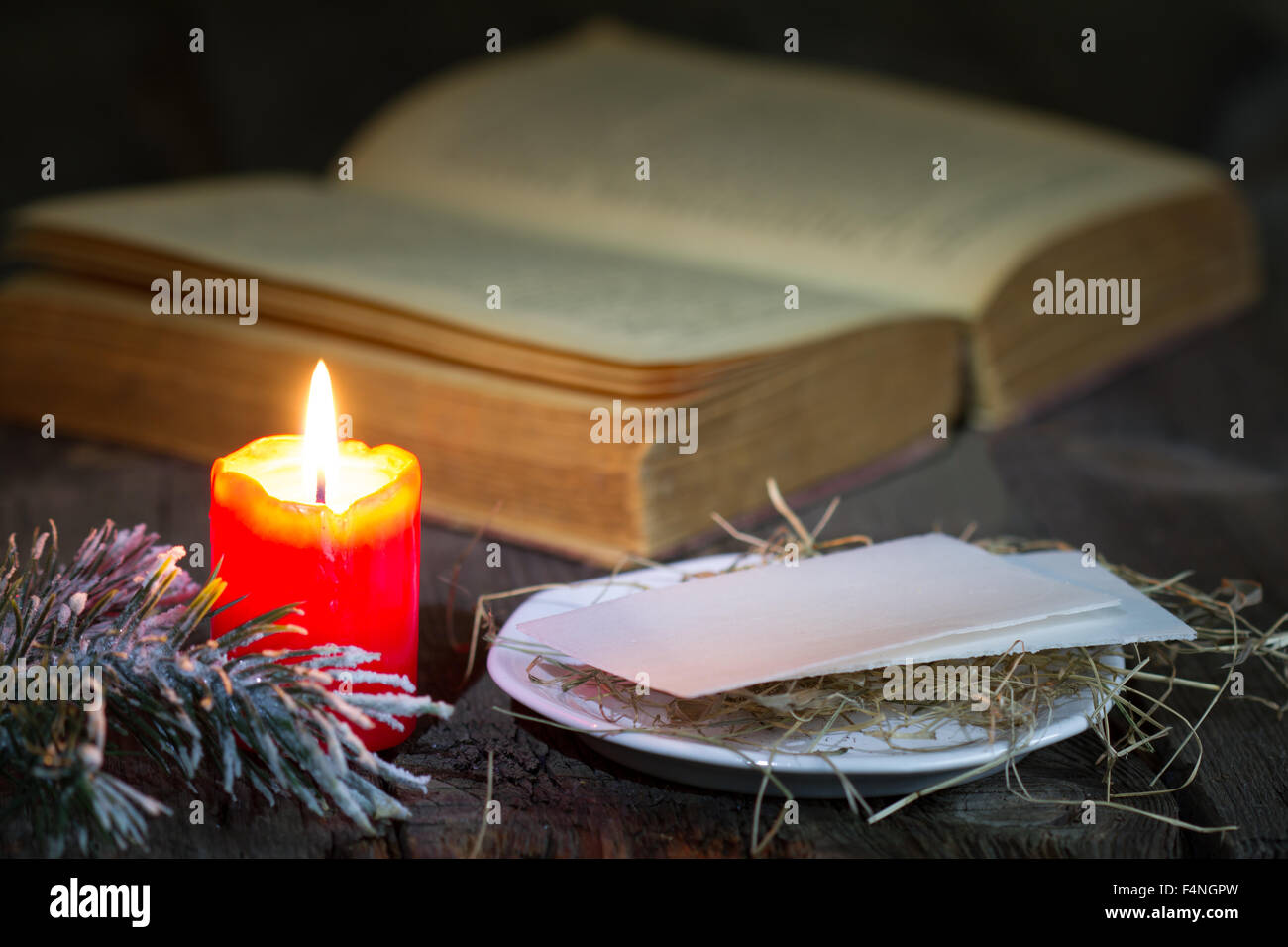 Bibel und Weihnachten rote Kerze auf dem Tisch durch Nacht Nahaufnahme Stockfoto