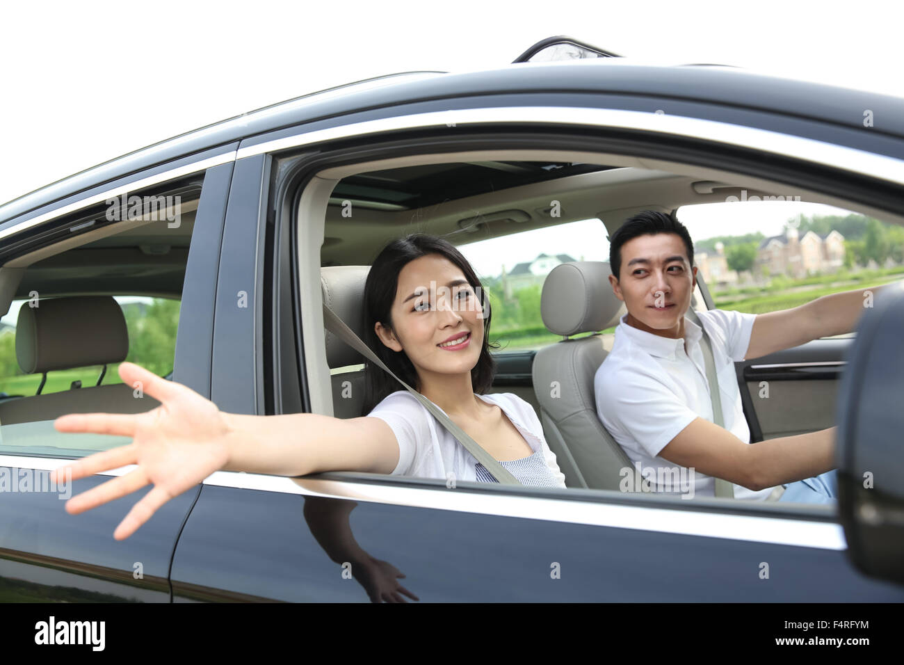 Junge Paare, die ein Auto fahren Stockfoto
