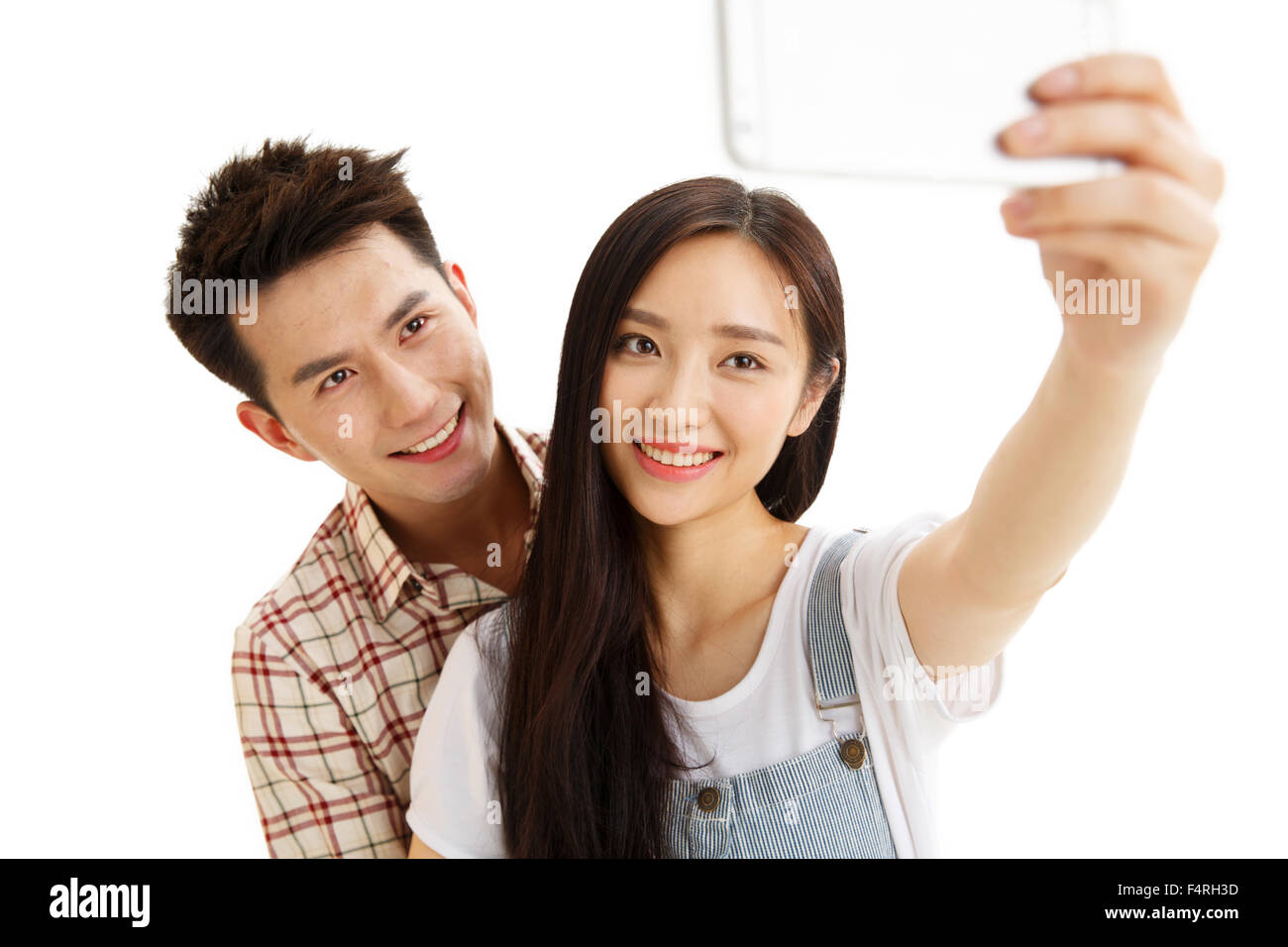 Junge Paare mit einer Handy-Kamera Stockfoto