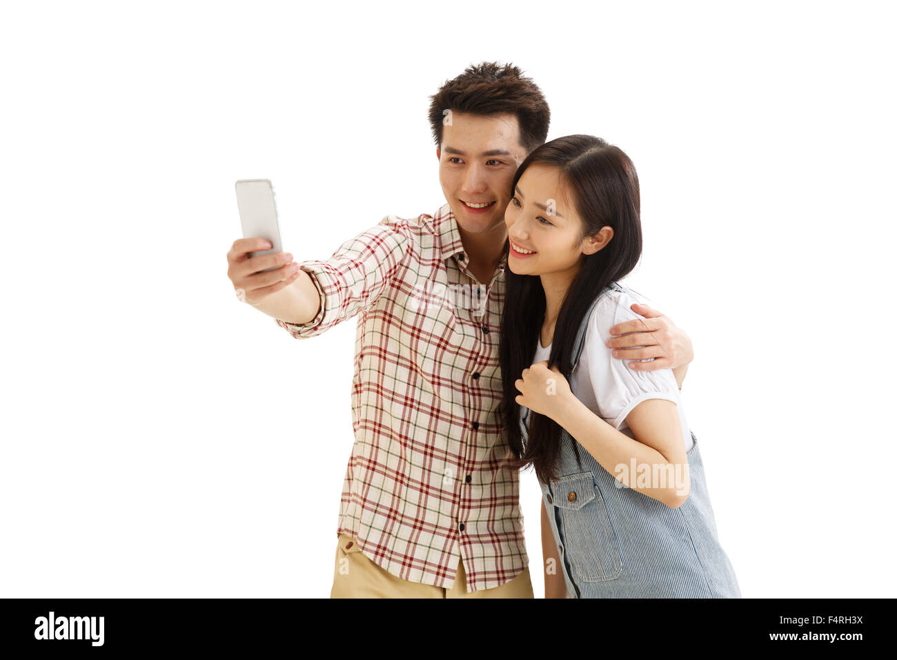 Junge Paare mit einer Handy-Kamera Stockfoto