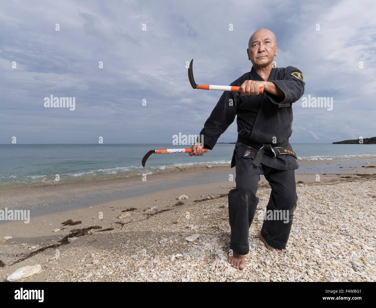 Kensho Tokumura Hanshi 9. Dan Ryukyu Dento Kobujutsu Hozon Budo Kyokai Training am Heshikiya Beach, Katsuren, Okinawa. 德村 賢昌 Stockfoto