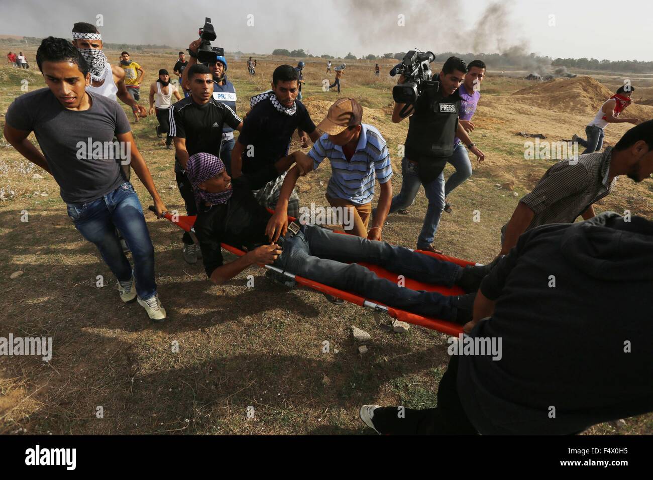 Buriej, Gazastreifen, Palästinensische Gebiete. 23. Oktober 2015. Palästinensische Demonstranten tragen einen verletzten Kameraden bei Zusammenstößen mit israelischen Sicherheitskräften in der Nähe der Grenze zwischen israelischen und zentrale Gaza-Streifen, am 23. Oktober 2015. Palästinensischen Fraktionen gefordert Massenkundgebungen gegen Israel in den besetzten Westjordanland und Ostjerusalem in einen '' Tag des Zorns '' am Freitag, als Welt und regionale Mächte angedrückt mit Vorträgen zu versuchen, mehr als drei Wochen des Blutvergießens Credit Ende: Yasser Qudih/APA Bilder/ZUMA Draht/Alamy Live News Stockfoto