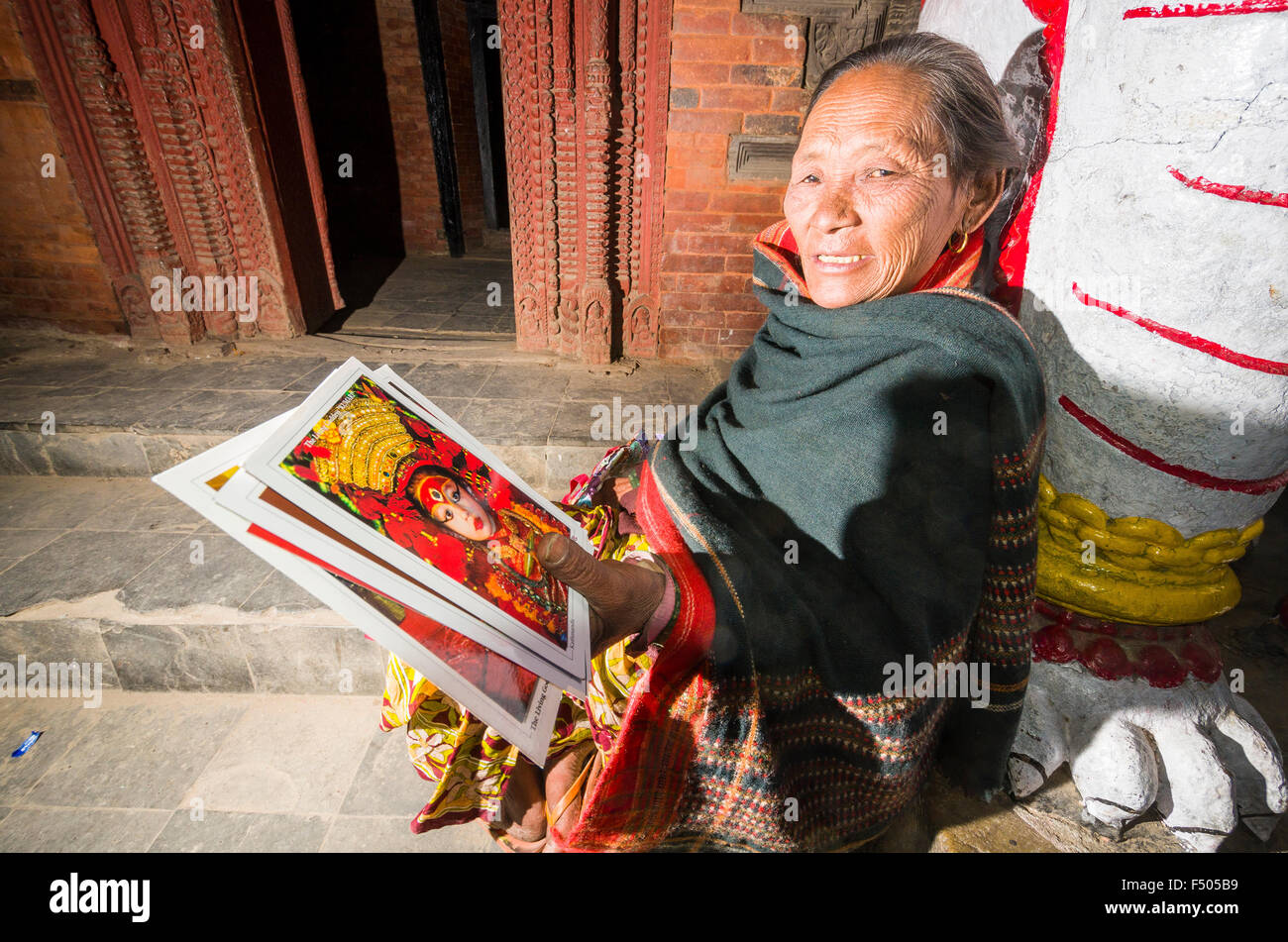 Alte Dame verkaufen Postkarten der lebenden Göttin Kumari Stockfoto