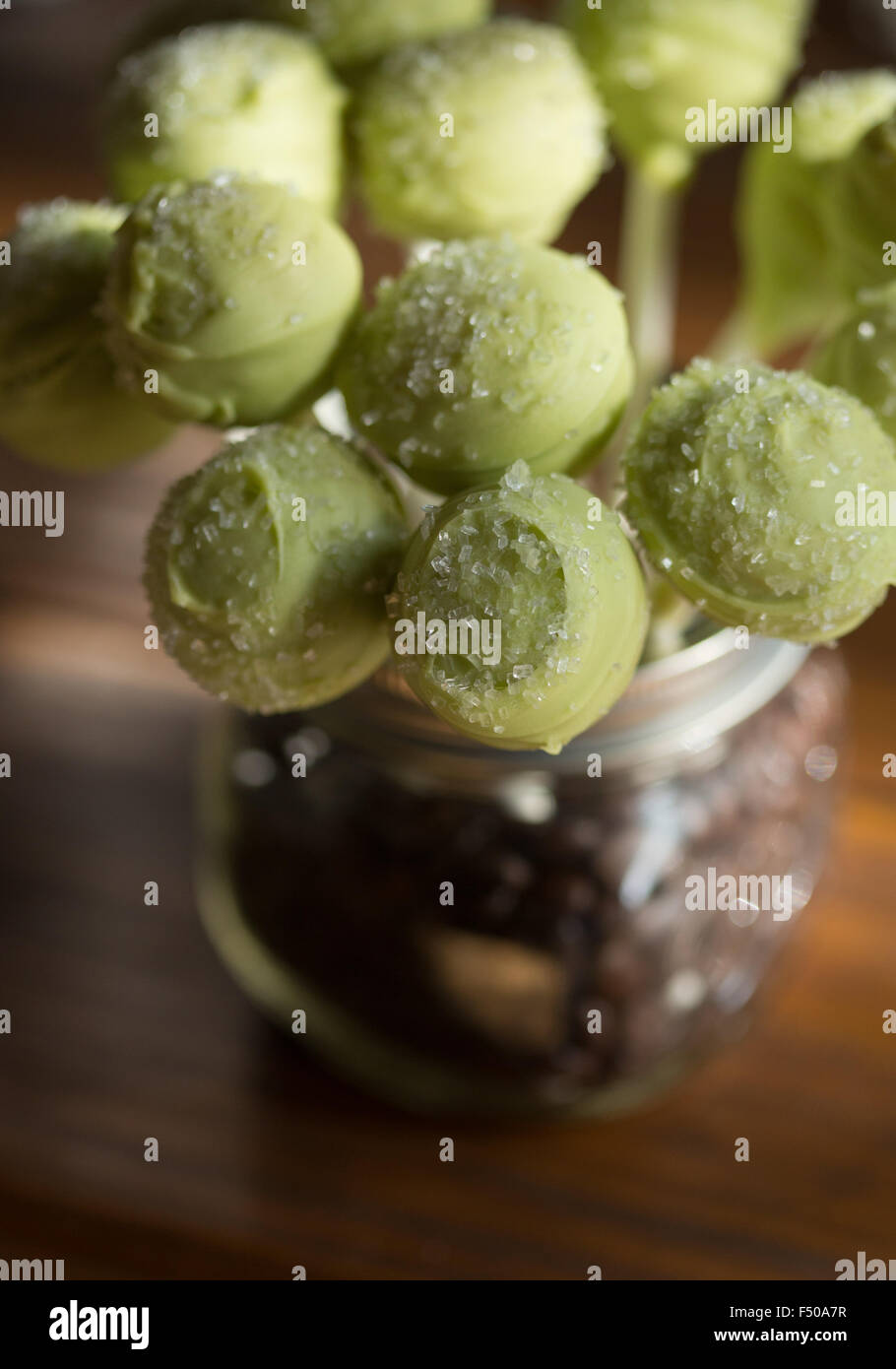 Grüne Kuchen pops in ein Einmachglas mit Kaffeebohnen gefüllt Stockfoto