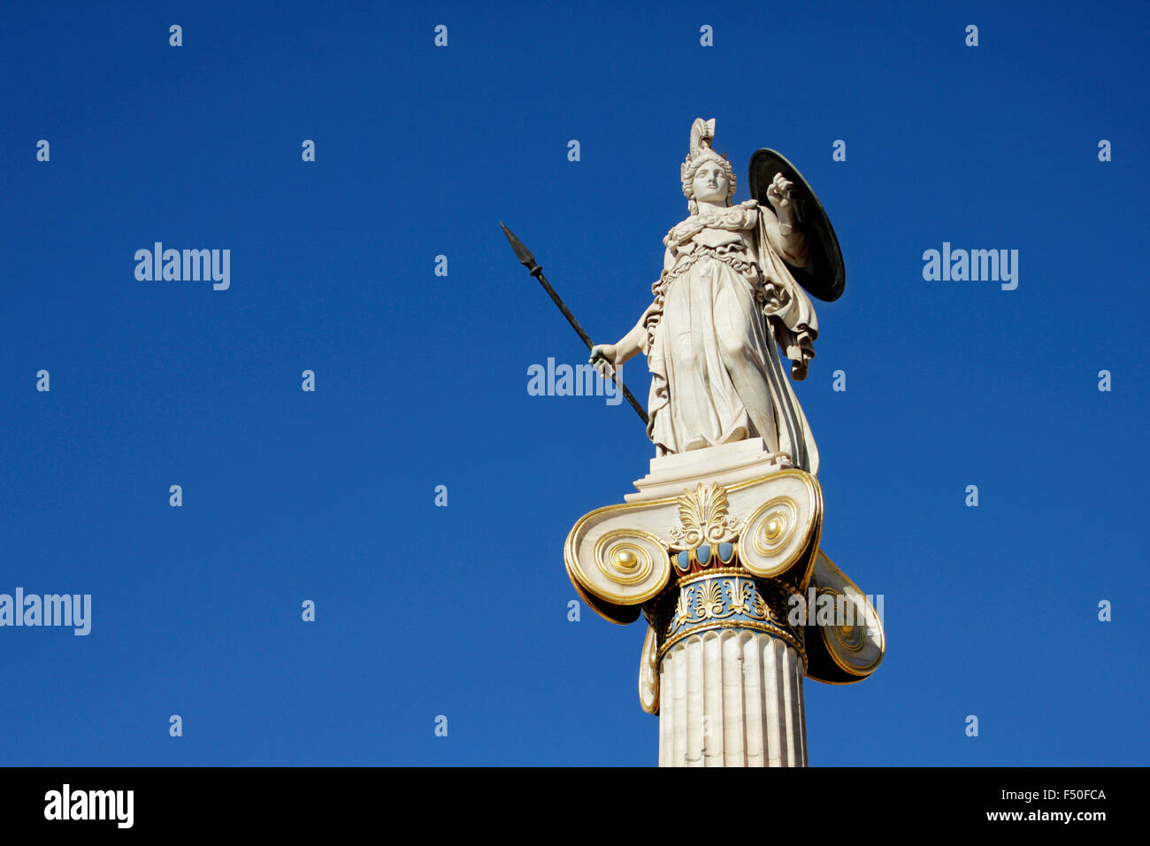 Marmorstatue der griechischen Göttin Athene / Pallas Athene hält ein Schild und Speer gegen blauen Himmel. Panepistimiou str. Athen, GR Stockfoto